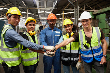 portrait group of workers joining hands for cooperation success work and project in the factory