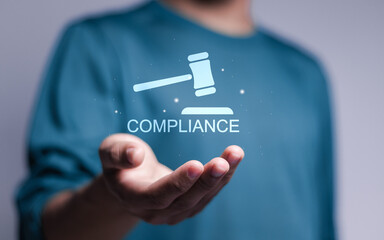 Compliance rules and law regulation policy concept. Person holding compliance icon on virtual screen. - obrazy, fototapety, plakaty