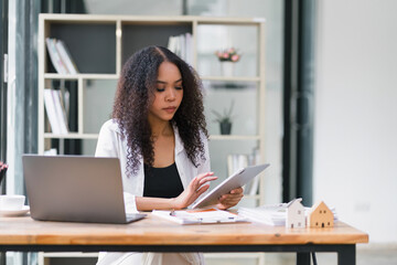 Young African American professional woman using a tablet at work.