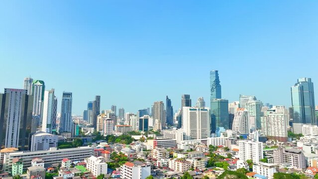 4K - Bangkok Thailand: Drone Aerial view, Towering skyscrapers adorn the bustling cityscape, a modern marvel against the horizon. A metropolis alive from above. Iconic landmarks concept.
