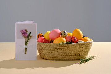 Easter colored eggs in a wicker basket. Easter composition.