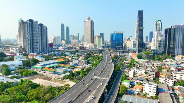 4K - Bangkok Thailand: Drone Aerial view, View reveals metropolis's concrete jungle, towering structures dominate the economic center. Transportation concept.
