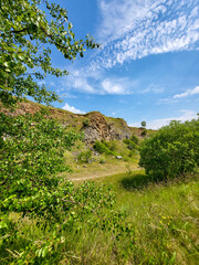The basalt columns of Racos, Coloanele de bazalt de la Racos, stone wall in nature with blue sky,...