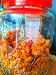 A jar with roasted peanuts inside