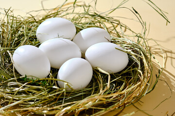 Farm natural white eggs in a nest of grass.