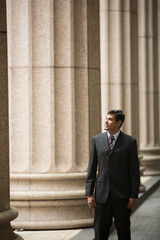 Indian Lawyer or business man outside a colonial building.