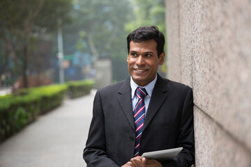 Indian businessman using digital tablet computer.
