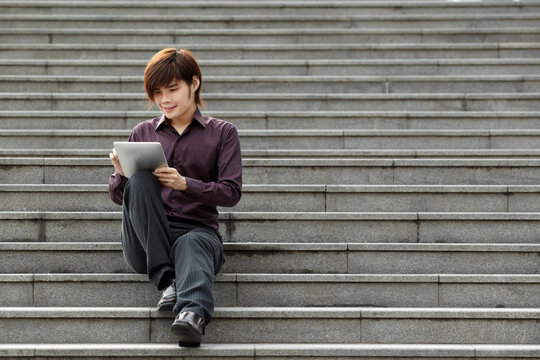 Asian Business Man Using A Digital Tablet