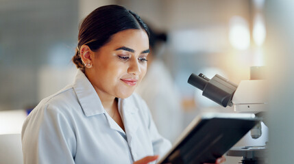 Scientist, woman and tablet, microscope or laboratory research for DNA analysis and happy with medical study. Student or science expert in biotechnology with digital software and lens check for data