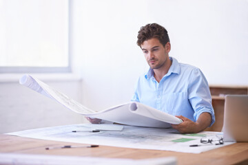 Architect, contractor or man in office with blueprint, thinking and reading paper for renovation....