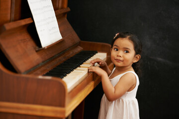 Piano, girl and baby in home for learning, practice and classical education with musical notes....