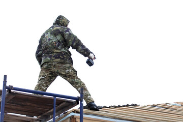 Workers install tiles on the roof of a house in winter