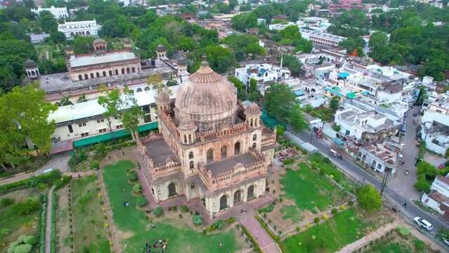 Aerial drone shot of mosque in indian city with lush green environment and houses of lucknow india