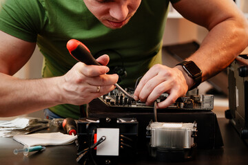 Close up of man repairing computer system unit