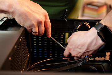 Close up of man repairing computer system unit