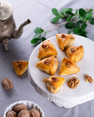 Novruz sweet pastry with nuts and sugar filling - baked mini rolls, shekerbura, pakhlava, sweet kete, eastern pastry for Ramadan, turkish or arabic culture, new year celebration in Baku