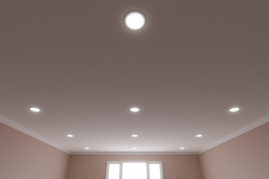 Recessed ceiling lights in a white stretch ceiling.