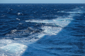 Seascape ocean view from cruiseship cruise ship liner making waves plowing through the sea cruising