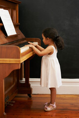 Piano, girl and toddler in home for learning, practice and classical education with musical notes....