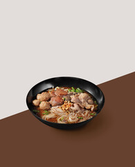 Chinese beef noodle in a bowl on color background