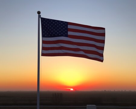 American flag flies in wind at sunset, american flag image
