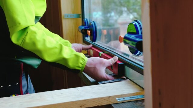 The skilled tradesman installs the double-glazed window with care.