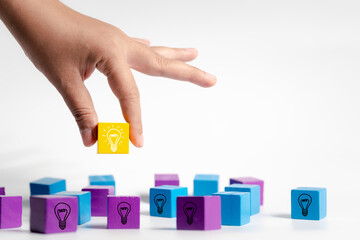 Explore hands engaging with colored wooden blocks, evoking creativity and concept creation...