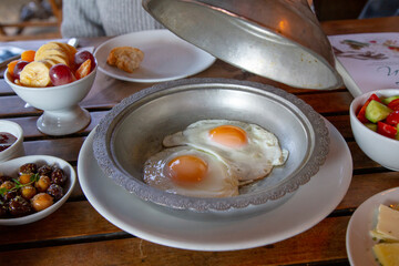 fried eggs fried in a frying pan for breakfast with bread. Traditional Turkish breakfast. Sunny...