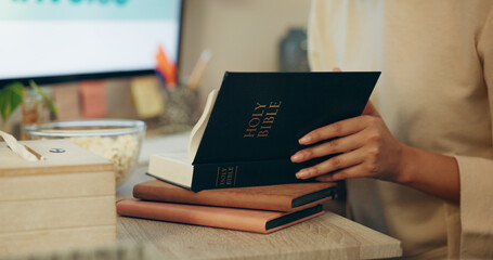 Bible, religion and hands of person reading holy Christian book to worship God for spiritual...