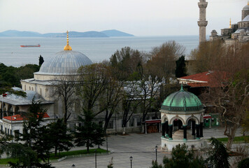 Aerial view of the historic part of Sultanahmet district with Hippodrome Square and German fountain, part of Blue Mosque with Bosphorus Strait in the background in Istanbul, Turkey