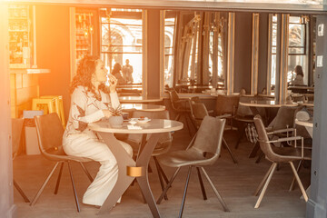 Woman cafe coffee breakfast. Portrait of an adult beautiful woman in an elegant suit in a cafe