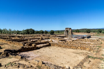 View of the remains of the Roman city of Cáparra with the famous quadrifront arch in the background. Cáceres, Extremadura, Spain.
