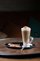 Cup of coffee latte on the table, dark background, restaurant menu