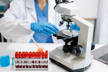 female scientist working with micro pipettes analyzing biochemical samples, advanced science...