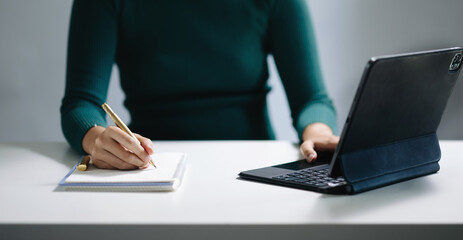 businesswoman hand working with new modern computer and writing on the notepad strategy diagram
