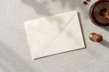 Envelope Mockup. Top view blank card on earthy neutral colors cloth background. with clipping path.