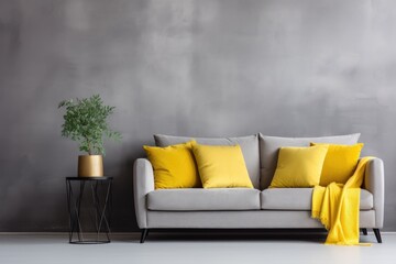 A photo showing a grey couch adorned with yellow pillows, accompanied by a potted plant.
