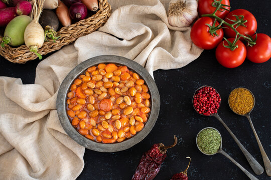 Vegan food named barbunya pilaki . Beans cooked with olive oil , tomatoes and carrot. 