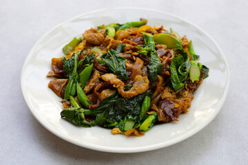 Stir-fried rice noodles with soy sauce and pork