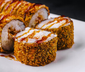 Warm tempura sushi rolls close up