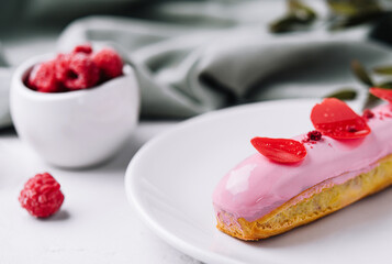 delicious eclairs with pink raspberry glaze