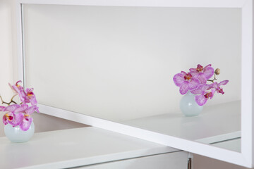 purple orchid in glass vase on white background
