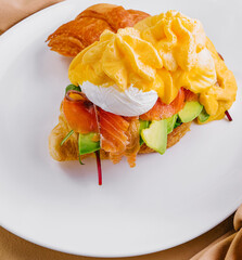 fresh croissant with smoked salmon top view