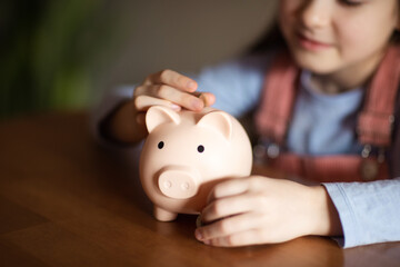 child holding pig piggy bank. concept of saving money, investments, loans to families, deposits for education