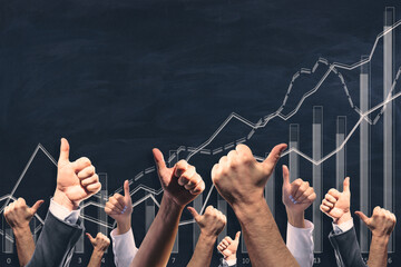 Various male and female hands showing thumbs up on chalkboard wall background with business chart.