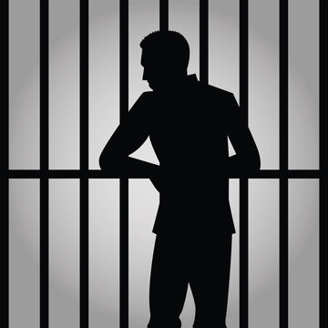 silhouette of a prisoner behind bars