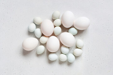 Easter eggs on the white table, tender light composition