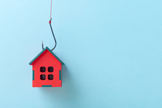 House on a Fish Hook over blue background with copy space, Concept of Real Estate Investment Danger