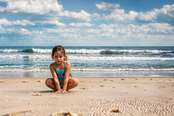 Fototapeta na wymiar Bambina in Spiaggia alla Ricerca di Conchiglie