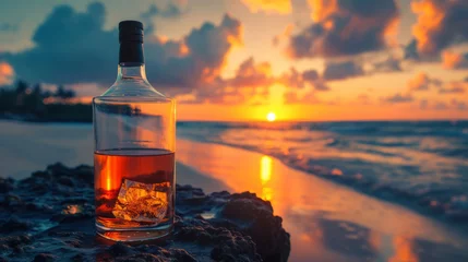 Fotobehang Bottle of whisky on a table with beach sea and sunset in background © standret